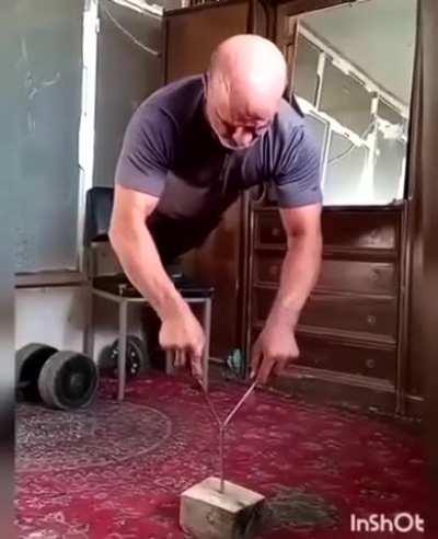 Push-ups with screwdrivers balanced on a spike