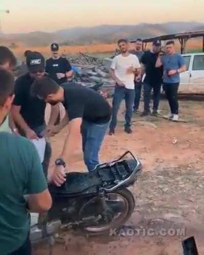 Pour gasoline on a fire made by a motorcycle