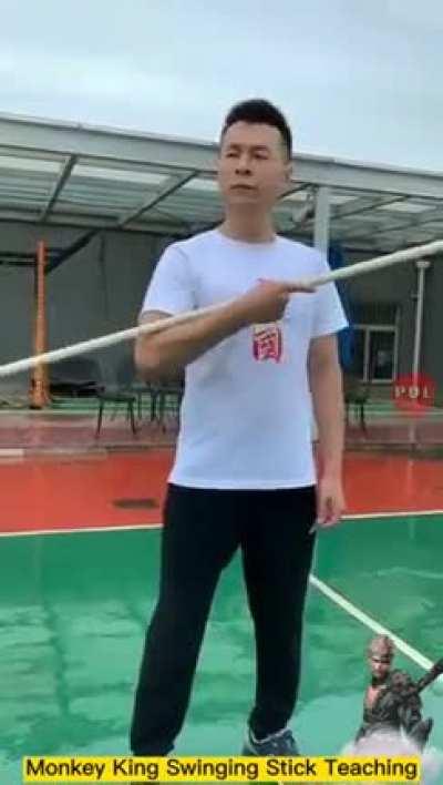 Wushu teacher demonstrates the speed of the monkey king swing stick or Ruyi Jingu Bang.
