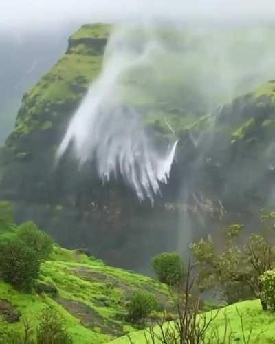 Strong winds causing this waterfall to spray upwards
