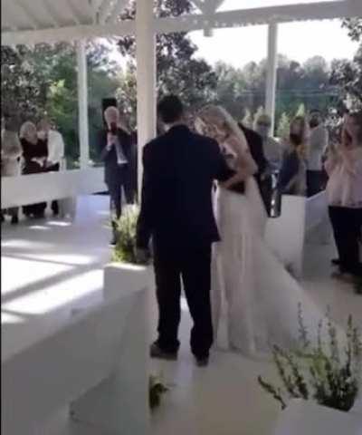 Father stops midway down the aisle to ask his daughter's Step-Father to join them