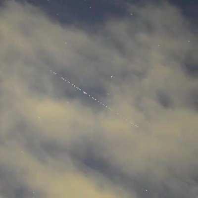 A train of SpaceX Starlink satellites seen travelling high over Japan