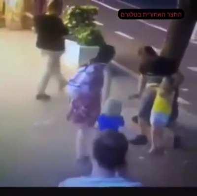 Woman stabs child in the face with knife & attempts to stab the other in public for no reason