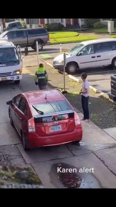 Karen refuses to back up for a garbage truck on a one lane road