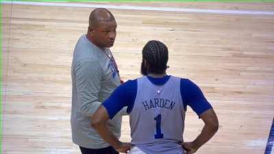 Doc Rivers has a conversation with James Harden following practice