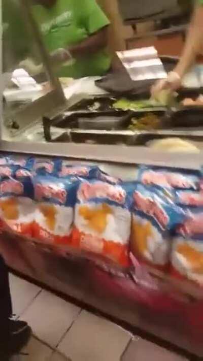 Woman alternatives between politely ordering her sandwich and arguing with Subway worker.