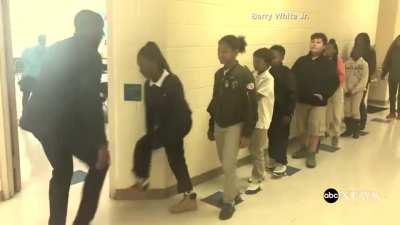 Teacher has incredible handshake with each student very wholesome .