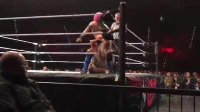 Asuka With a Stinkface to Dana Brooke.