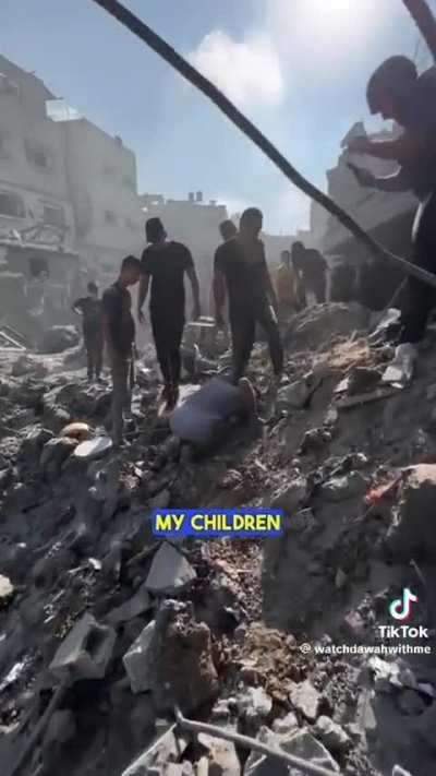 Gazan father searching through rubble to find his children. 