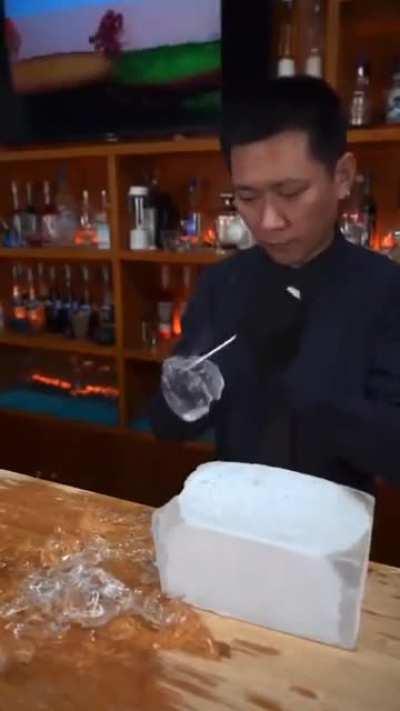 Bartender makes a perfect ice ball
