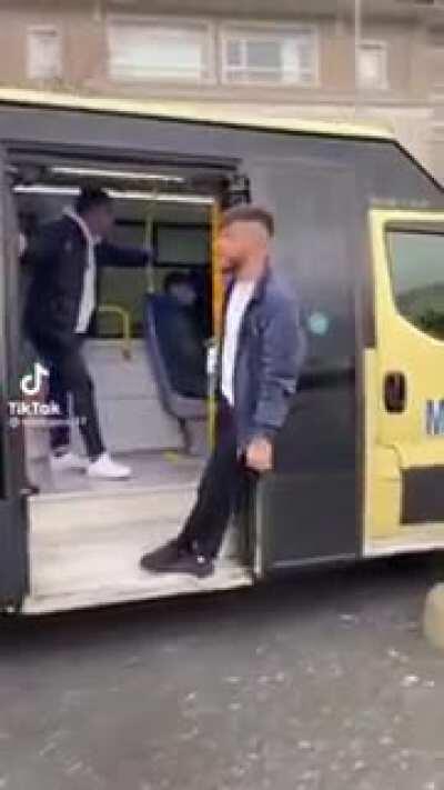 Hanging from the door of a bus