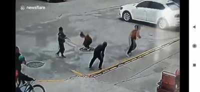 Kid throws fire cracker in manhole and gets a jump