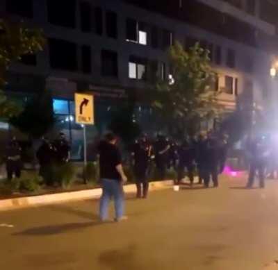 Protester gets a flash-bang to his face after getting pepper sprayed.