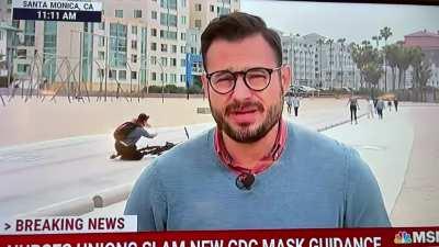 To take a cool selfie while riding a bike through a reporters spot.