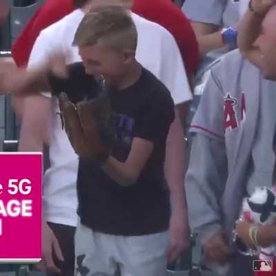 Man gives baseball to kid in the stands and later the kid catches a ball and returns the favor