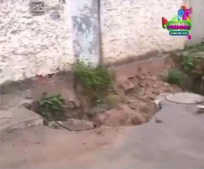 WCGW Riding a bicycle too close to a sinkhole.