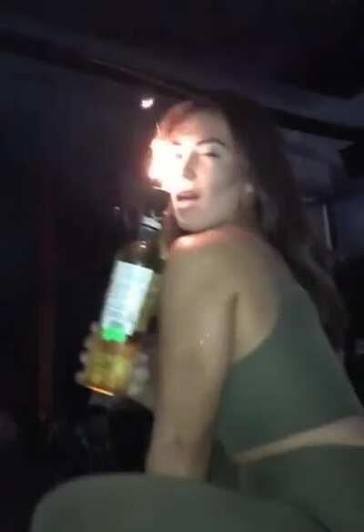 Posing too close to a sparkling bottle