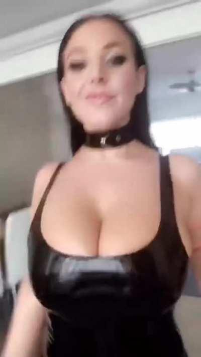 Angela walking in a latex dress