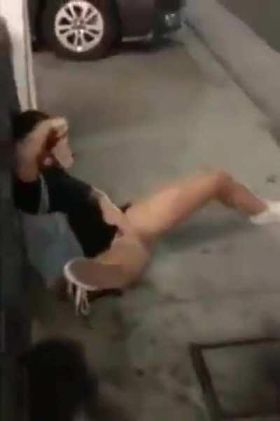 Two girls peeing along a busy street