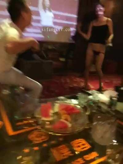 Chinese Waitress serving a bottle of beer