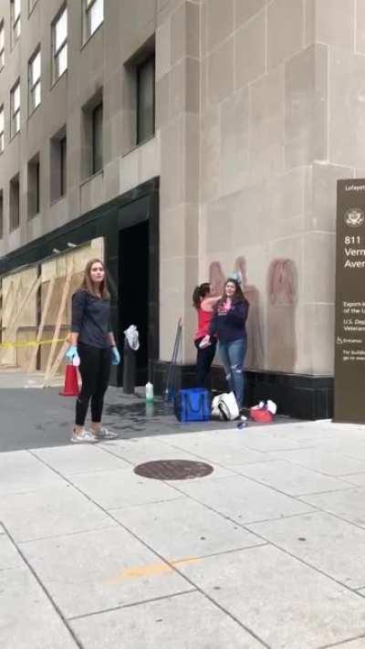 Girls cleaning a building in their city are yelled at