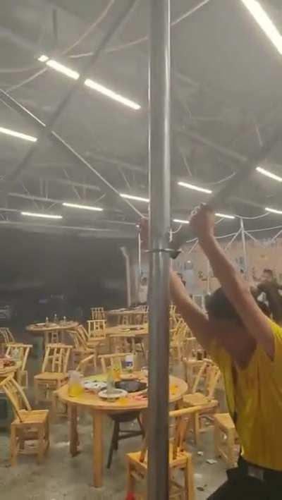 Holding onto a tent during a storm