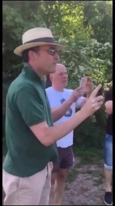 Guy pushes photographer into pond