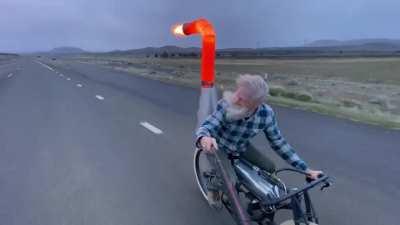 Man riding a jet-powered bicycle