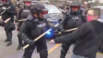 Trying to attack a cop with a large block of concrete