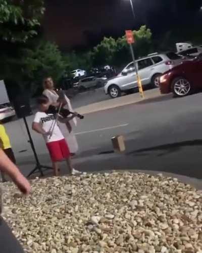 This kid just jamming out in the parking lot