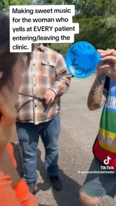 Fuck you. Lady harassing people outside a family planning clinic.