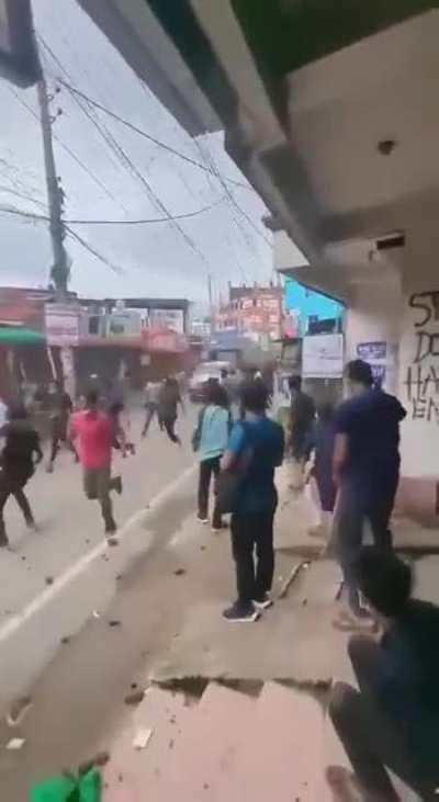 Bangladesh Police driving a vehicle through protesters.