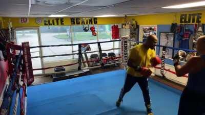 Going into a boxing gym and challenging the trainer