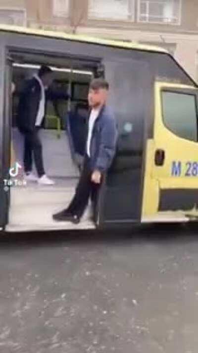 Hanging from the door of a bus