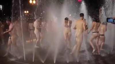 Playing in a fountain completely naked