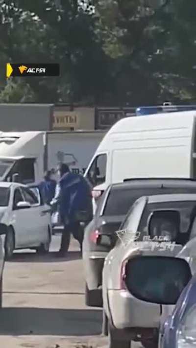 Paramedic explaining the car driver that he has a right of way.