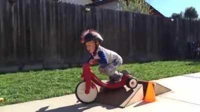 Riding a tricycle over a ramp