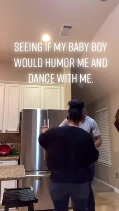 Son Came Home From College And Mom Is Seeing If He'll Humor Her With A Dance