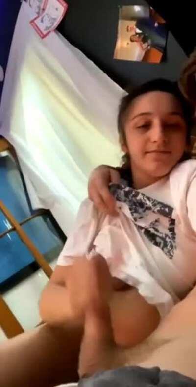 Jerks him on to her tits