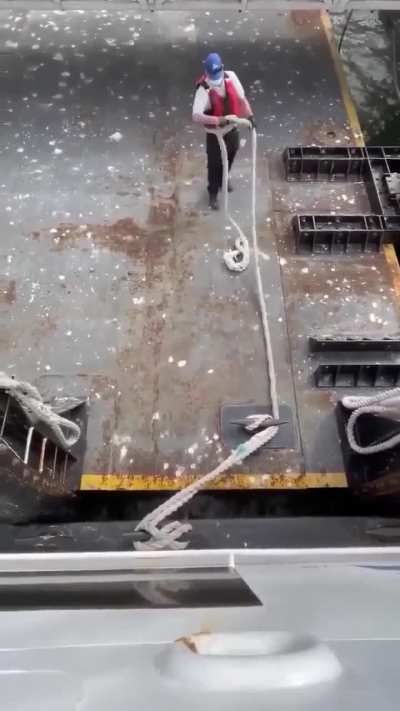 Dock worker skilfully tying the mooring line