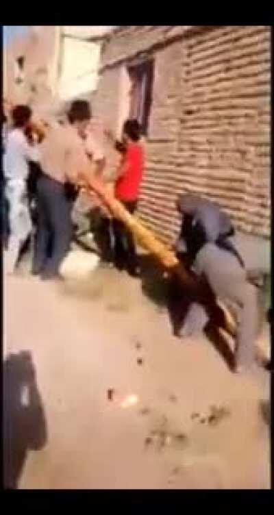 Villagers “fixing” live electricity pylon