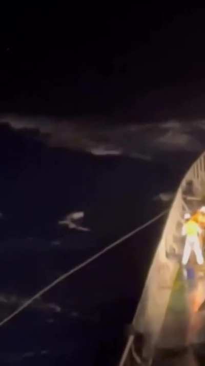 Rescue of a sailor on a sailboat during a storm in the Atlantic Ocean