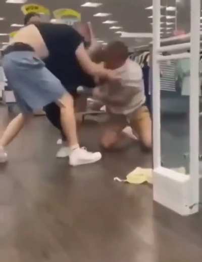 Two guys fight in a UK store and one takes a tumble