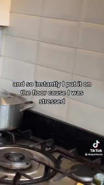 Guy set a hot pan on a wood floor