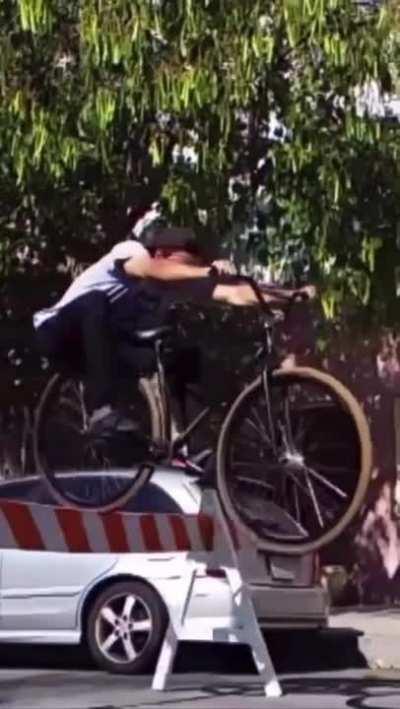 Jumping a road block with a bike.
