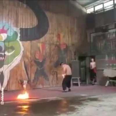 Some person throws fire up in the air and tries to catch it with is pants.