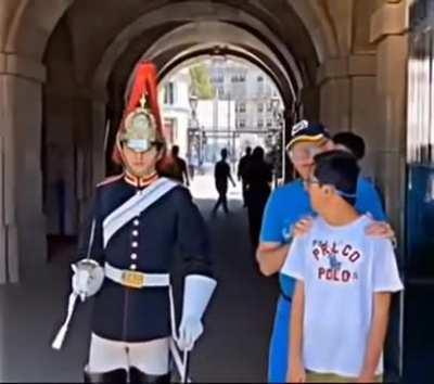 Dad makes sure his child remains a safe distance from the guard.
