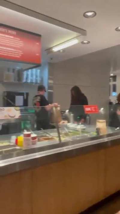 Guy playing a saxophone with traffic cone appendage