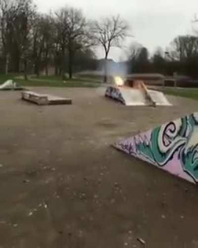 Guy lights fire in between bottles filled with flammable liquid