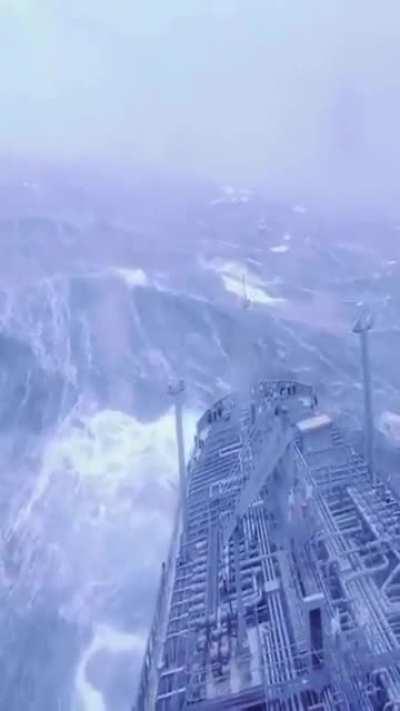 Ship struggling with giant waves in the ocean